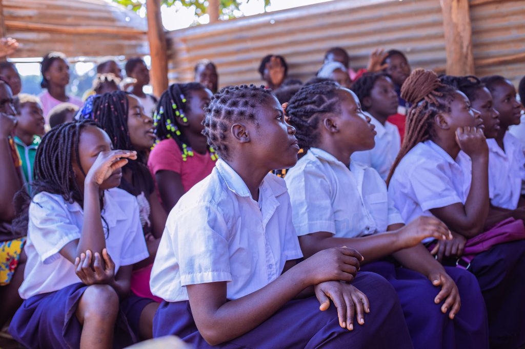 Children sat in school concentrating on the teacher teaching