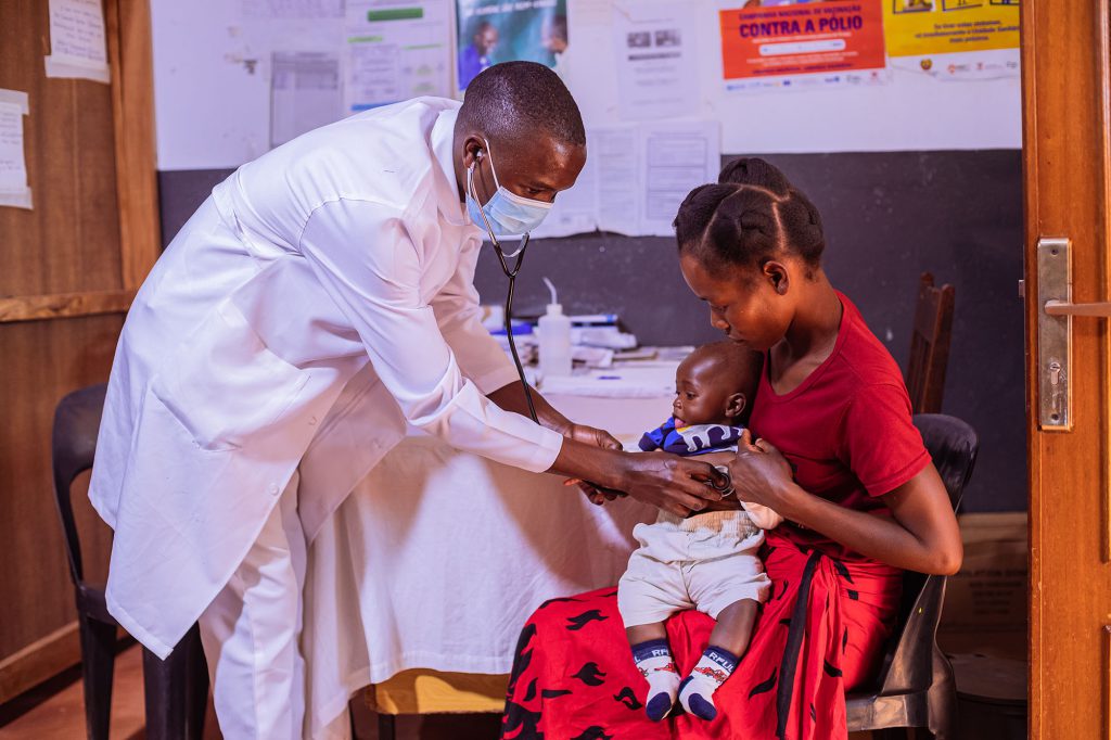 Doctor checking heart beat of young child