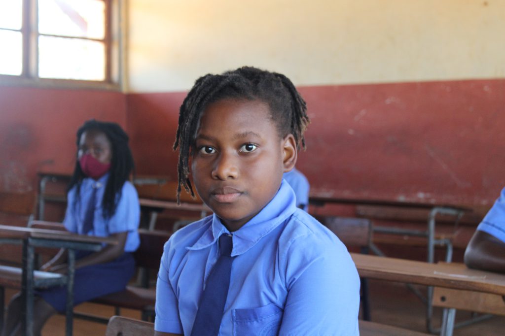 Emilia a pupil sat in classroom at school