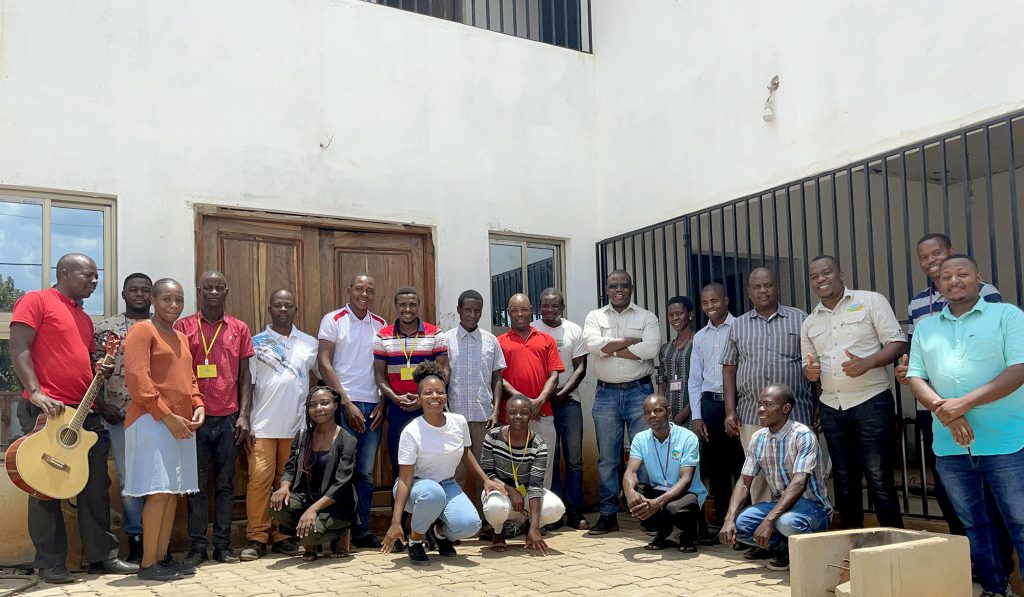 Group of Village Water partners stood outside building
