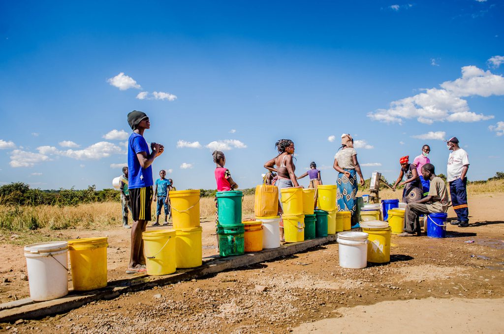 Local community waiting for fresh water from local water pump