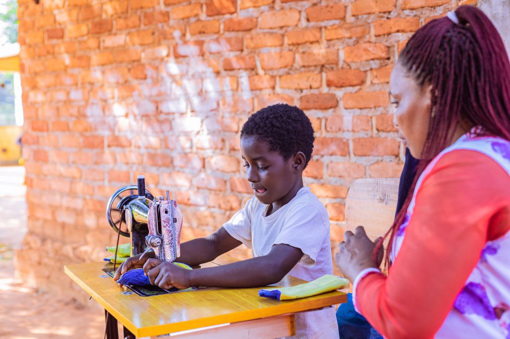 Young child using a sewing machine